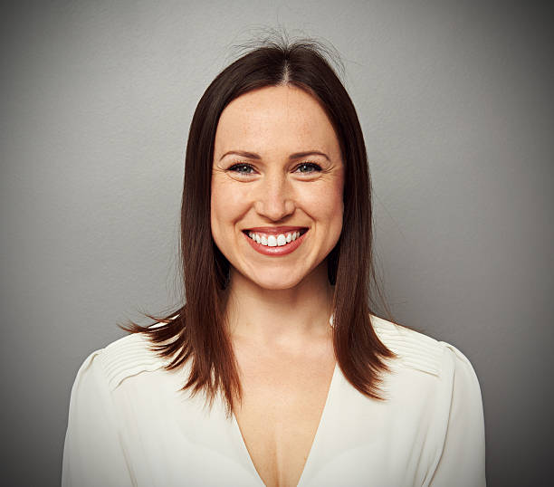 istock happy young woman in white blouse 185998756