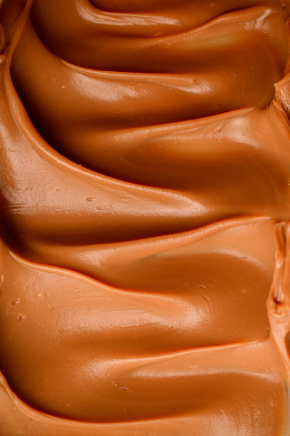 istock Photo from above, close-up of brown cream, distributed evenly with a wavy surface 1859989566