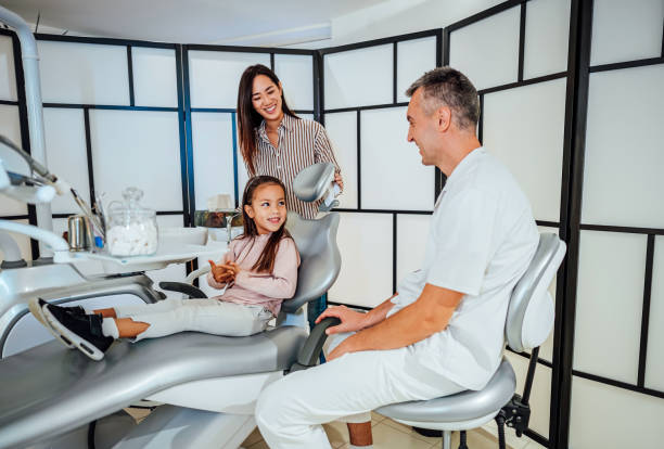 istock Cute girl at the dentist for a routine checkup 1860001080