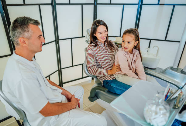 istock Cute girl at the dentist for a routine checkup 1860002538