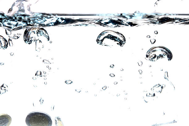 istock Euro coins falling into the clear water 186000270