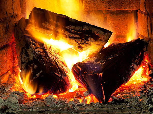 istock burning fuelwood in fireplace 186000674