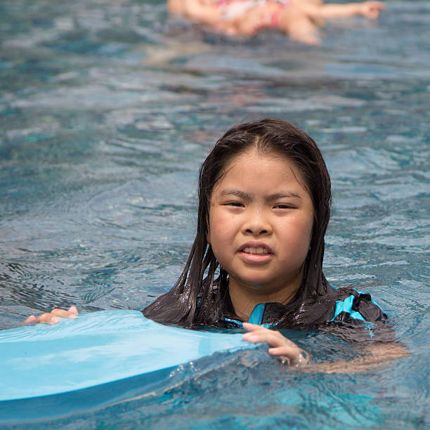 istock girl in pool 186001248