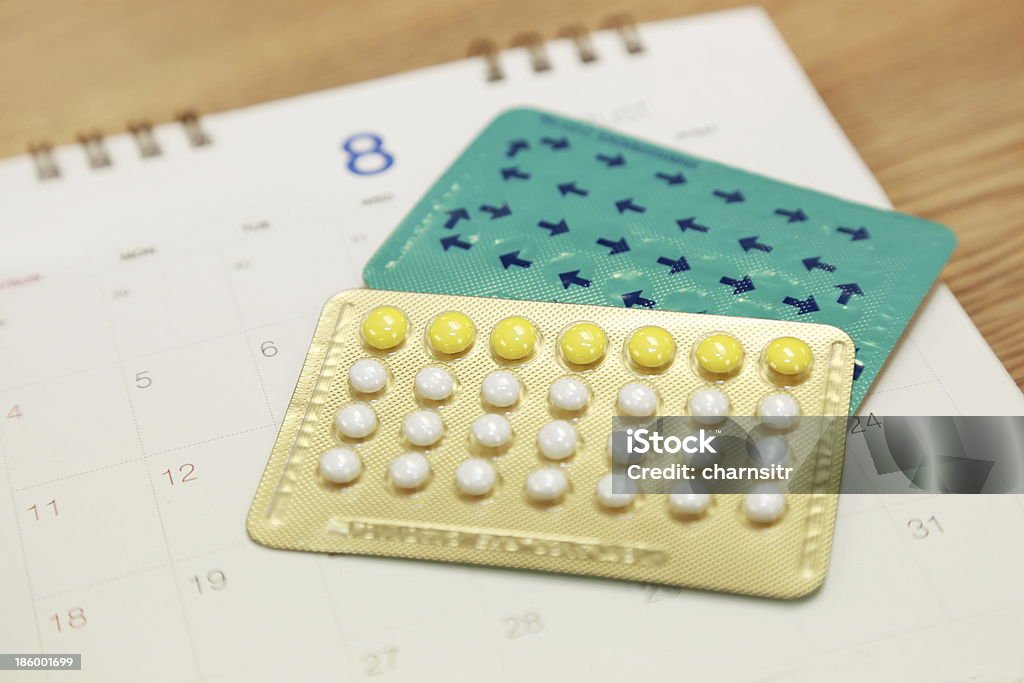 birth control pills on a calendar Birth Control Pill Stock Photo