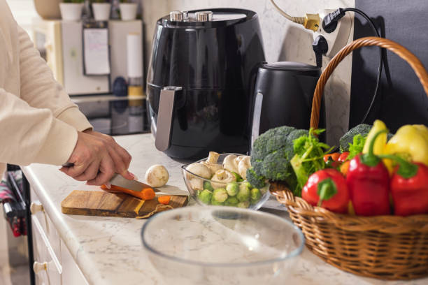 istock Woman chopping vegetables in the kitchen 1860034433