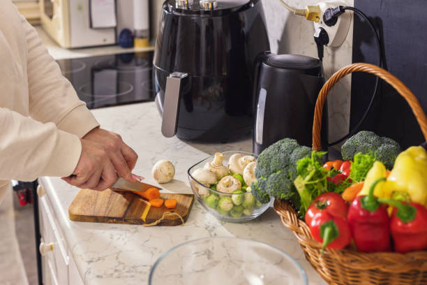 istock Woman chopping vegetables in the kitchen 1860034978