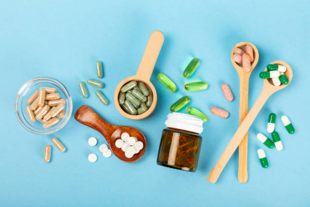 istock Vitamins and supplements. Variety of vitamin tablets  on a texture background.Multivitamins with fresh and healthy fruits.Food supplements. Flat lay. Space for text.Copy space 1860039102