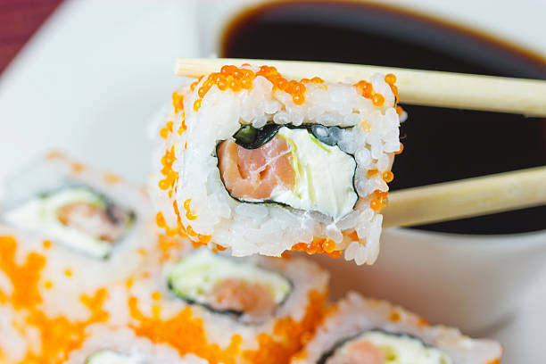 istock One piece of Maki Sushi in chopsticks 186004299