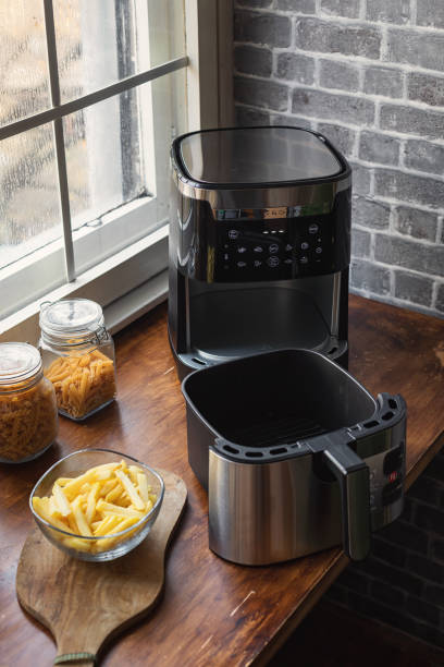Air fryer machine on the kitchen counter stock photo