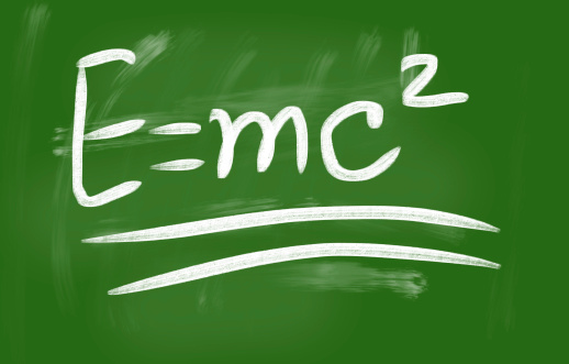E=mc2 handwritten with chalk on a blackboard