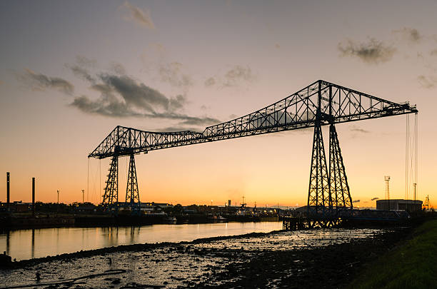 Middlesbrough Transporter Bridge at dusk The Middlesbrough Transporter Bridge carries people and cars over the Tees in a suspended gondola middlesbrough stock pictures, royalty-free photos & images