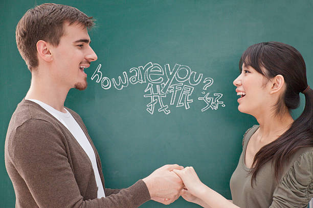 Students in front of chalkboard holding hands Students in front of chalkboard holding hands chinese script photos stock pictures, royalty-free photos & images