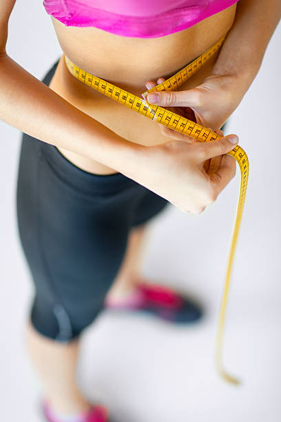 istock trained belly with measuring tape 186008086