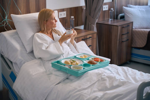 istock Hospitalized patient pondering over something during lunchtime in ward 1860103458