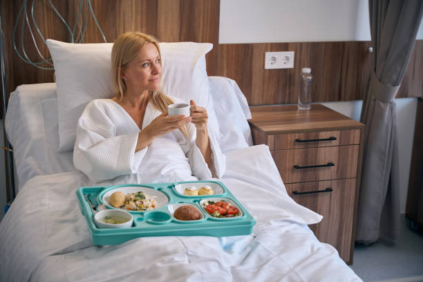 istock Female inpatient thinking about something during lunchtime in ward 1860103969