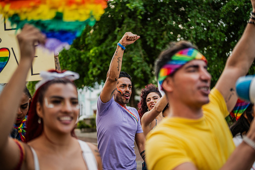 LGBTQIA+ people marching during social movement protesting outdoors