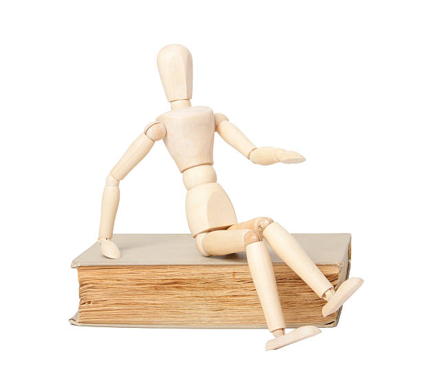 istock Wooden man and book 186016971