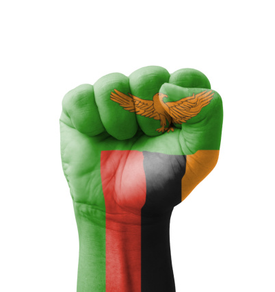 Fist of Zambia flag painted, multi purpose concept - isolated on white background