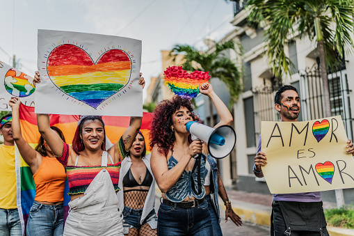 LGBTQIA+ people marching during social movement protesting outdoors
