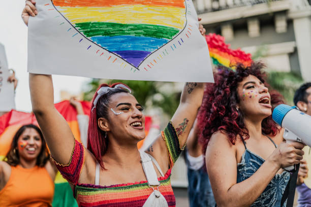LGBTQIA+ people marching during social movement protesting outdoors