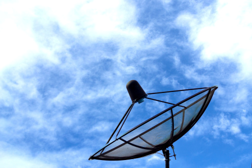 Satellite dish  on blue sky with clouds