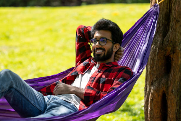 istock Man in hammock looking relaxed and contented 1860189724