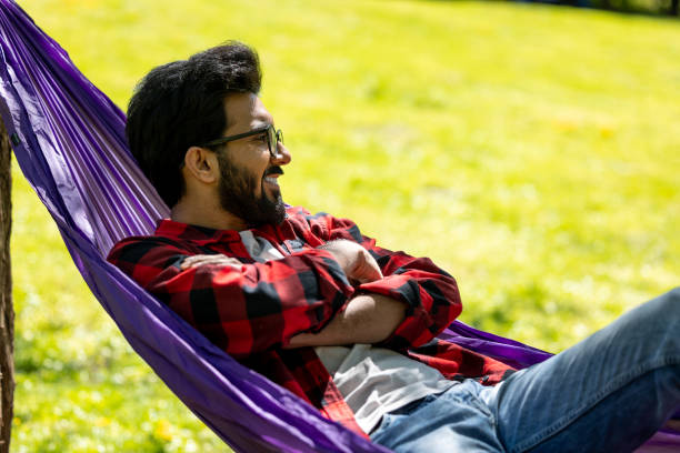 istock Man in hammock looking relaxed and contented 1860189733