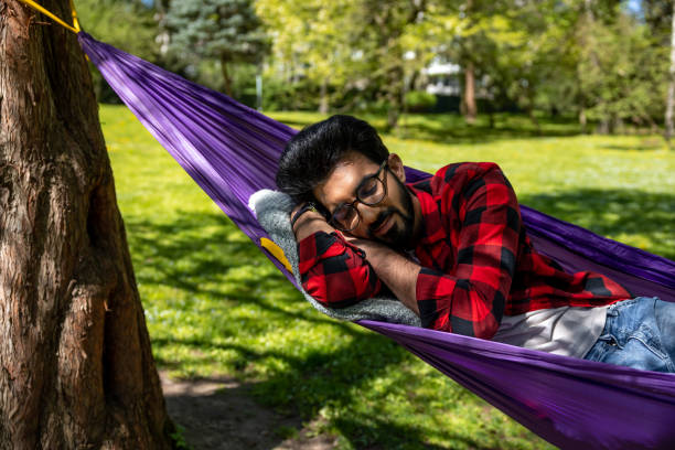 istock Man in a hammock feeling relaxed and rested 1860190843