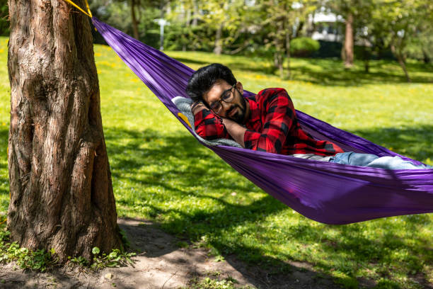 istock Man in a hammock feeling relaxed and rested 1860190855