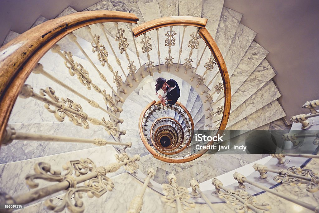 Just married couple together in a spiral staircase Spiral Stock Photo