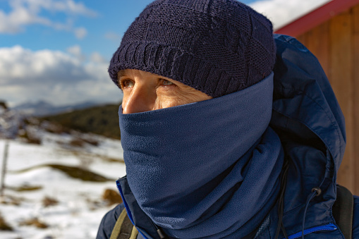 Burgos province, Castilla y León, Spain, From the mountain hut, the cold-weather-clad climber looks with concern at the upcoming ascent ahead.