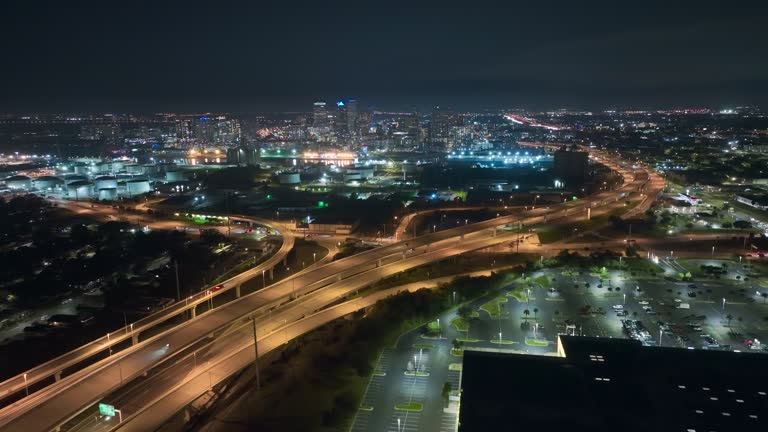 Aerial view of American highway junction at night with fast driving vehicles in Tampa, Florida. View from above of USA transportation infrastructure