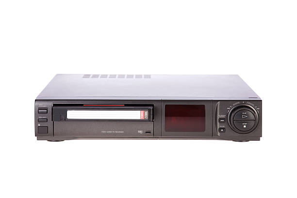 Old Video Cassette Recorder ejecting tape isolated on white background