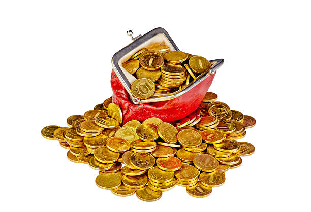 Old red purse with golden coins  isolated on white background