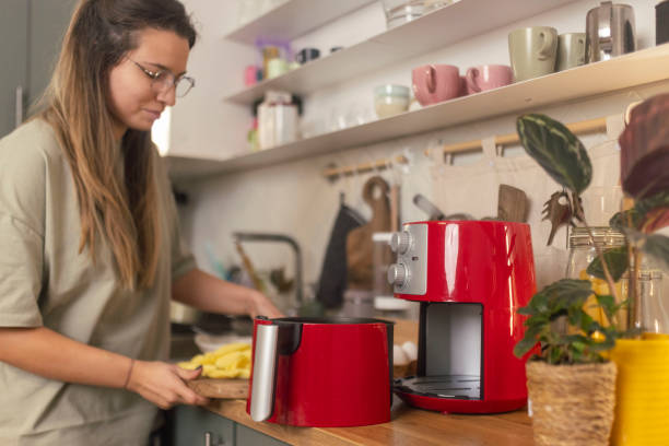 istock A beautiful woman preparing a meal using an air fryer 1860226583