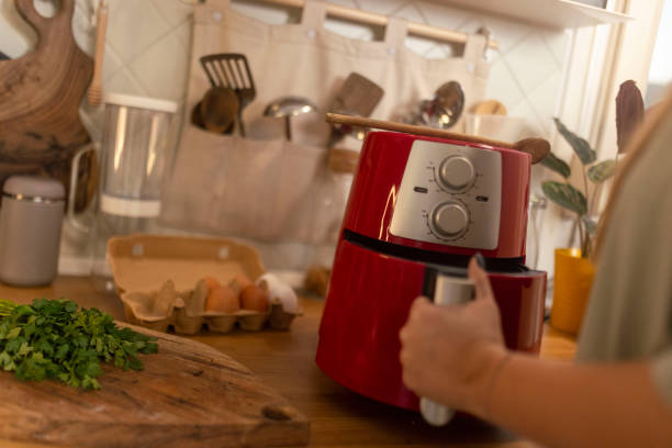 istock Unrecognizable woman preparing a meal using an air fryer 1860227130