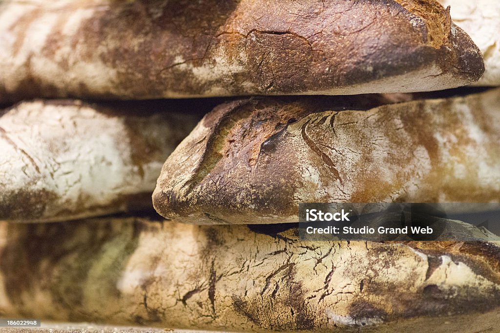 crusty wholewheat baguettes at traditional boulangerie close-up of organic baguettes in bread shop Baguette Stock Photo