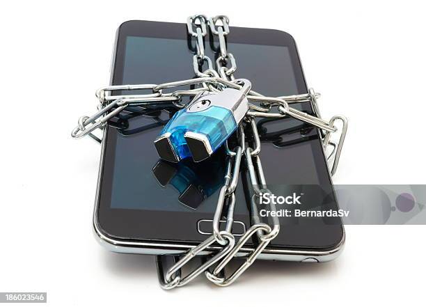 Mobile Phone Secured With Chain And Lock On White Background Stock Photo - Download Image Now