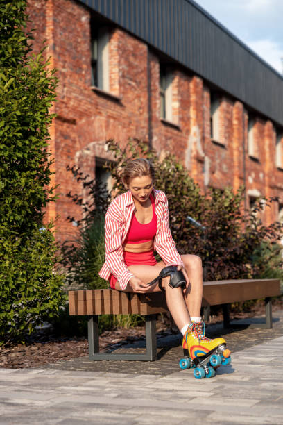 istock Woman having a rest on the bench after skating 1860237443