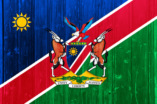 Flag and coat of arms of Republic of Namibia on a textured background. Concept collage.