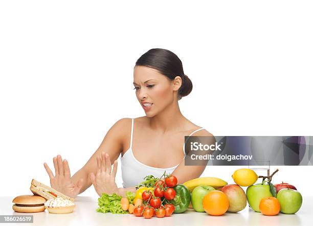 Woman With Fruits Rejecting Hamburger Stock Photo - Download Image Now - Carbohydrate - Food Type, Dieting, Refusing