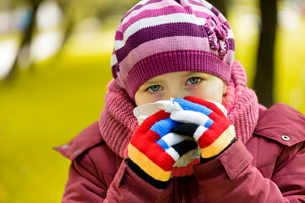istock Sick girl blowing nose 186029167