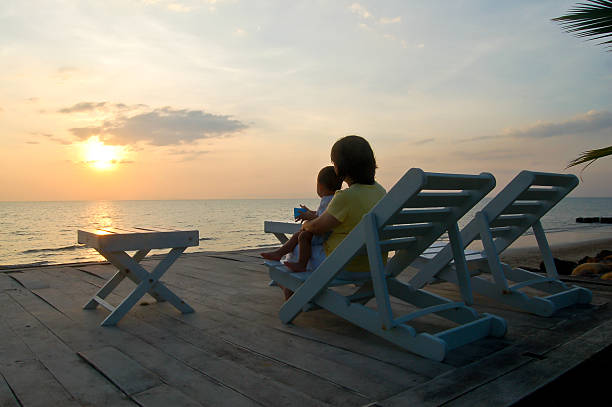 istock mother with baby in sunset 186029834