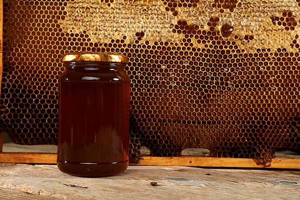 istock honeycomb with fresh honey in a vase on wooden table. 186032969