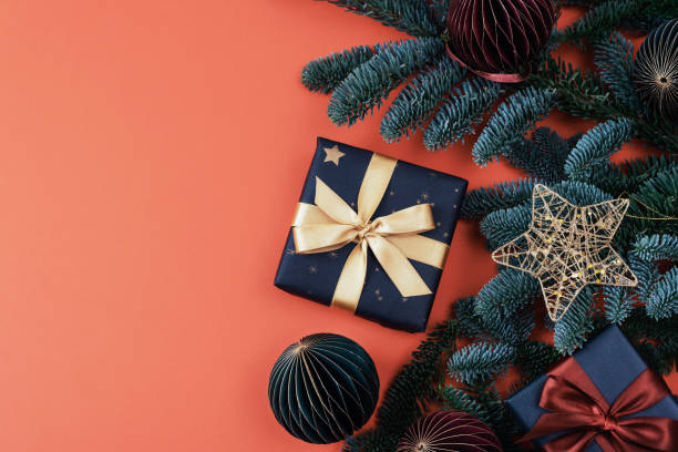 istock Christmas gift, baubles and fir branches on red background. Top view, flat lay, copy space 1860335316