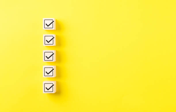 istock Checklist concept. Correct sign tick check mark on wooden block with copy space for the checklist on yellow background. Business survey questionnaire, Exam test process, filling digital form online, 1860338935