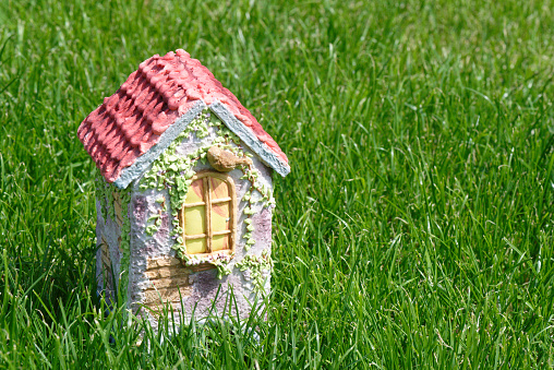 Gingerbread house on the green grass meadow