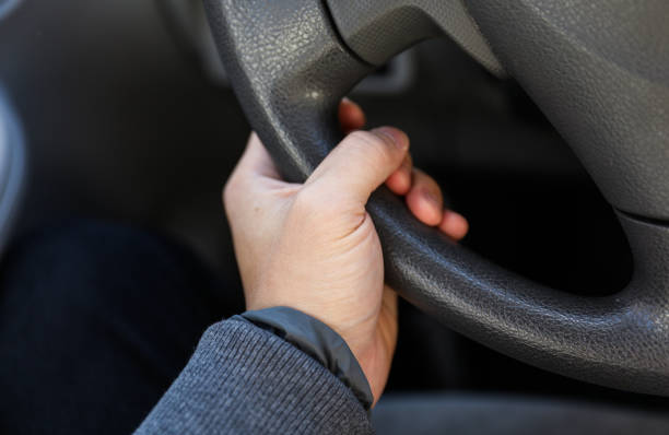 hands gripping a steering wheel, depicting control and navigation