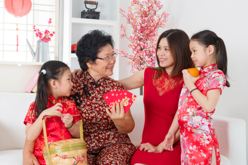 Happy multi generations Asian family celebrate Chinese new year at home.