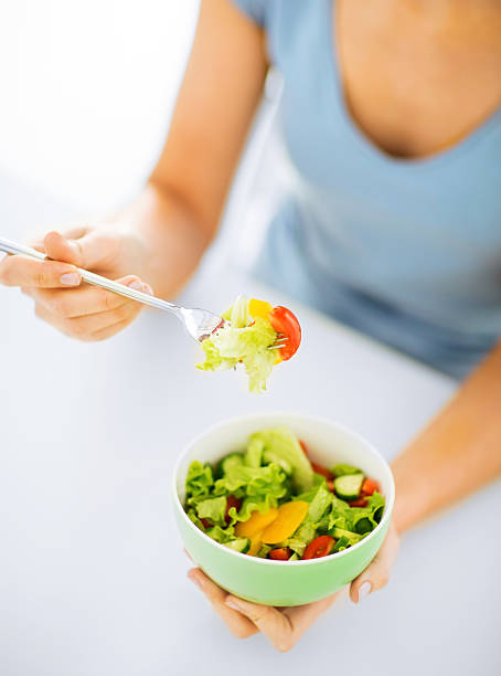 istock woman eating salad with vegetables 186035979